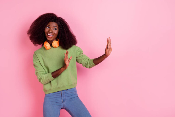 Photo of dreamy funny lady wear green sweater holding arms looking empty space isolated pink color background. - Foto, Imagen