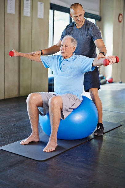 Strengthening one lift at a time. a handsome personal trainer with a senior man - Photo, Image