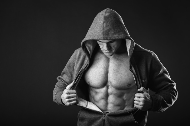 Muscular young man in hood jacket - Photo, Image