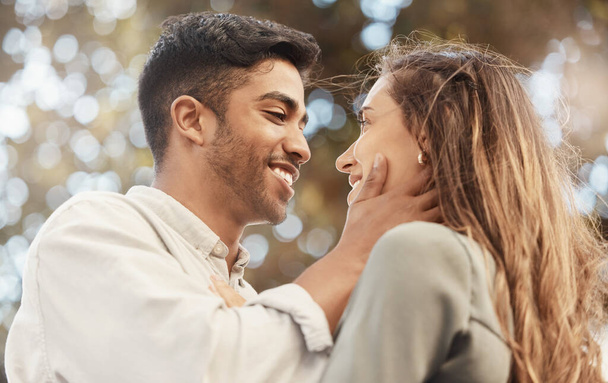 Happy couple, love and commitment while outside at a park sharing a romantic moment and looking into eyes with a smile. Safe, secure and happy man and woman showing appreciation, bond and connection. - Foto, immagini