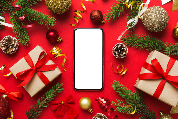 Digital phone mock up with rustic Christmas decorations for app presentation top view with empty space for you design. Christmas online shopping concept. Tablet with copy space on colored background. - Foto, Imagem