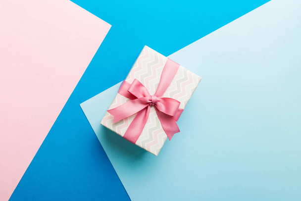 holiday paper present tied pink ribbon bow top view with copy space. Flat lay holiday background. Birthday or christmas present. Christmas gift box concept with copy space. - Fotoğraf, Görsel