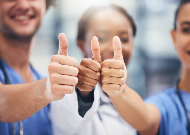 Doctors, nurses or thumbs up hands in success, teamwork collaboration or trust with medical winner goal. Zoom on thank you, motivation and vote emoji on man and support women in healthcare hospital. - Foto, afbeelding