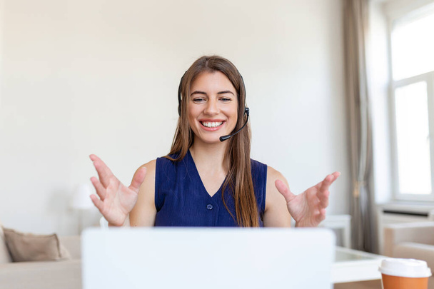 Снимок деловой женщины на видео-звонок, сидя за ее столом. Обрезанный снимок привлекательной молодой женщины, использующей ее ноутбук, чтобы сделать видеозвонок дома - Фото, изображение