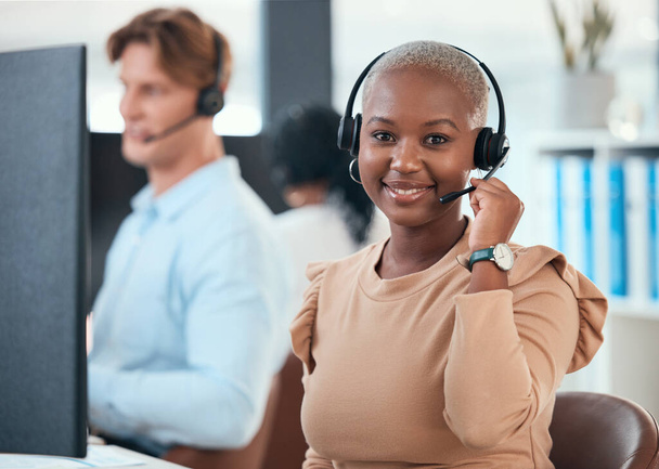 Call center woman, telemarketing and customer service consultant wearing a headset and looking happy at her office desk. Contact us and crm agent offering support and friendly service with a smile. - Fotografie, Obrázek