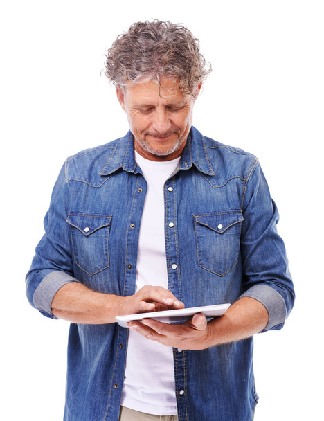 An isolated pose. Studio shot of a mature man using a tablet isolated on white - Fotoğraf, Görsel