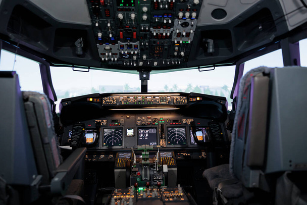 Nobody in empty airplane cockpit with dashboard command and power buttons, switch, lever and handle. No people in cabin with control panel navigation and radar compass, engine throttle. - Фото, зображення