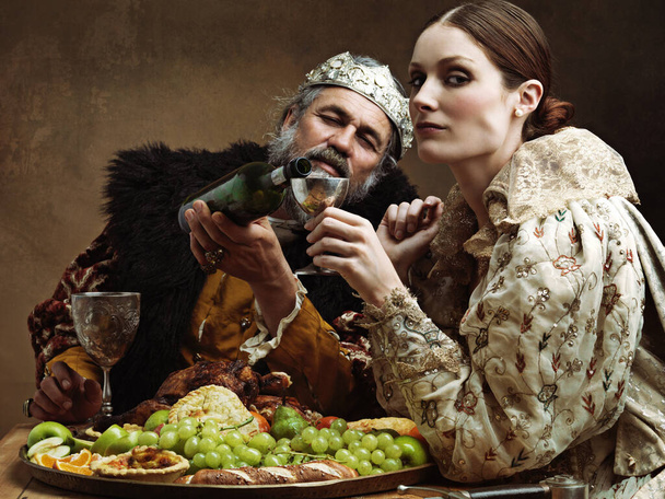 Its a rickety throne after enough mead. A bored queen sitting alongside her husband at a banquet - Photo, Image