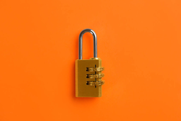 Modern combination lock on orange background, top view - 写真・画像