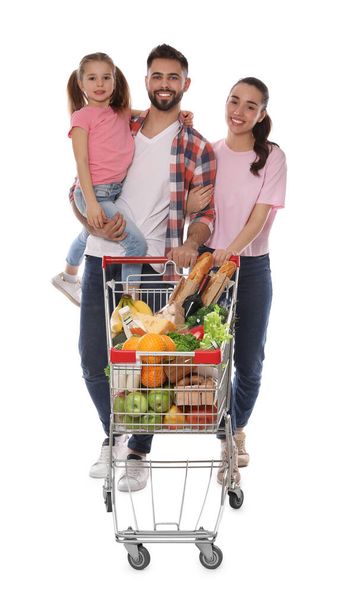 Happy family with shopping cart full of groceries on white background - Foto, Imagen