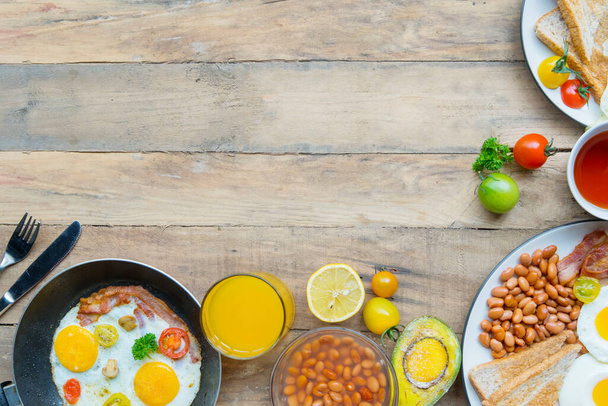 Top down view of variety breakfast foods served on the wooden table with copy space - 写真・画像