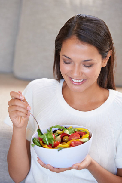 Happy salad day. an attractive young woman enjoying a fresh salad - Foto, immagini