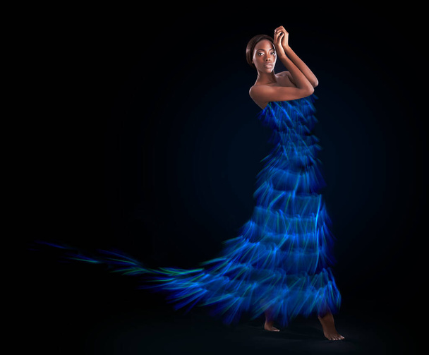 Ready to light up the room. Studio shot of a beautiful woman wearing a digitally enhanced dress against a black background - Фото, зображення