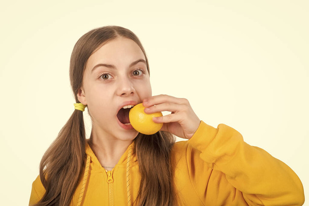 cheerful teen girl with citrus fruit lemon full of vitamins isolated on white, detoxication. - Photo, image