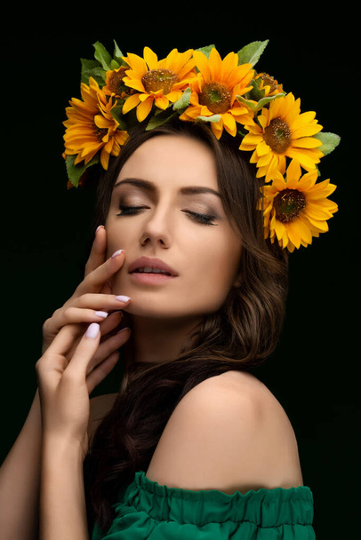 Portrait of a Ukrainian girl in a wreath of colorful yellow sunflowers. National traditional flower headdress. Ukraine concept. Stop war. High quality photo - Φωτογραφία, εικόνα