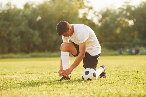 Preparing for the game. Young soccer player have training on the sportive field. - Φωτογραφία, εικόνα