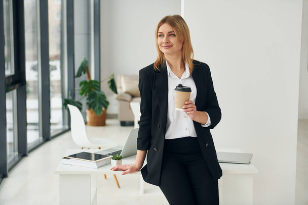 Woman in formal clothes is indoors in the modern office at daytime. - 写真・画像