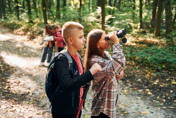 Conception of hiking. Kids in green forest at summer daytime together. - Foto, Imagen