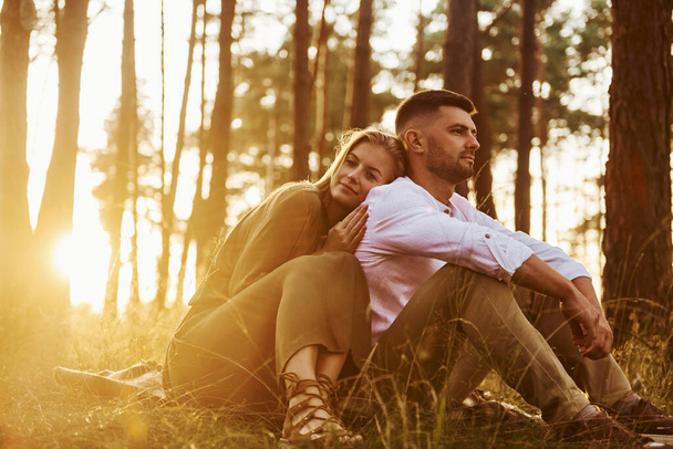 Resting in the forest. Happy couple is outdoors at daytime. - Foto, immagini