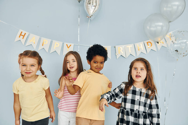 Children on celebrating birthday party indoors have fun together. - Fotó, kép