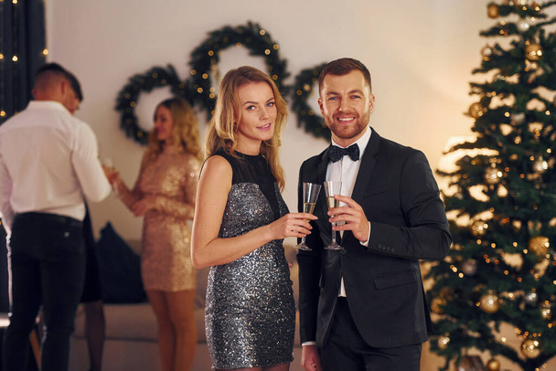 Group of people have a new year party indoors together. - Zdjęcie, obraz