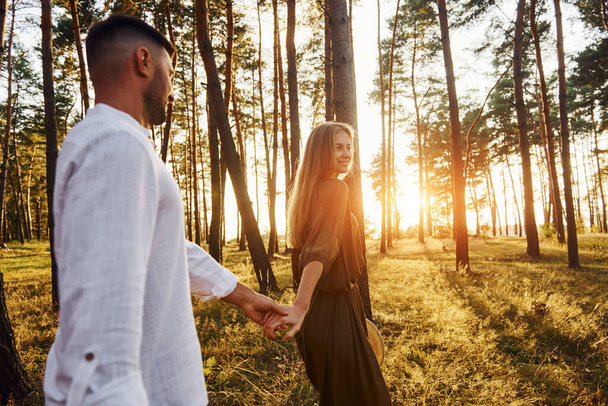 Non urban scene. Happy couple is outdoors in the forest at daytime. - Foto, Imagem