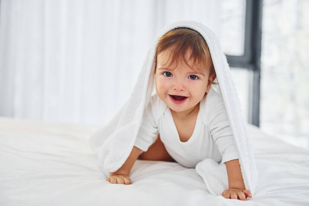 Having fun. Cute little baby is indoors in the domestic room. - Foto, Imagem