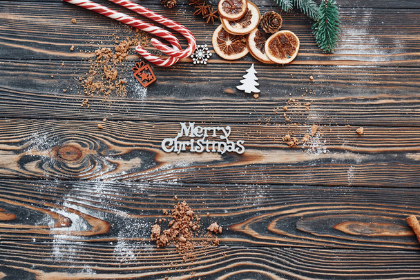 Candies and slices of oranges. Christmas background with holiday decoration. - Foto, imagen