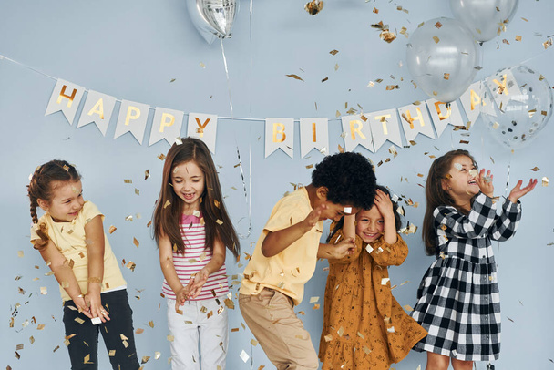 Children on celebrating birthday party indoors have fun together. - Photo, image