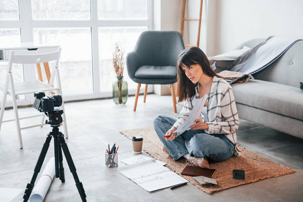 Makes content for blogging. Camera on the floor. Young female freelance worker is indoors in home at daytime. - Fotografie, Obrázek