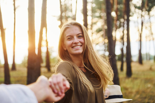 Happy couple is outdoors in the forest at daytime. - Fotoğraf, Görsel
