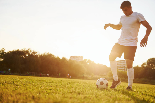 Doing different tricks. Young soccer player have training on the sportive field. - Fotoğraf, Görsel