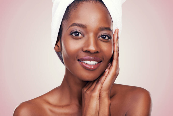 Her flawless skin speaks volumes. Studio shot of a beautiful young woman wearing a towel on her head - Fotó, kép