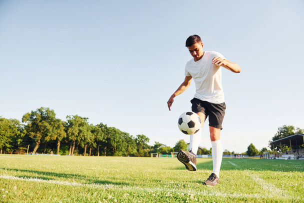Summer daytime. Young soccer player have training on the sportive field. - 写真・画像