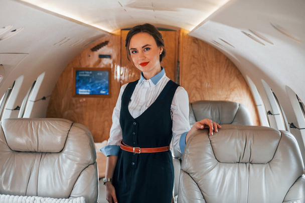 Young stewardess on the work in the passanger airplane. - Valokuva, kuva