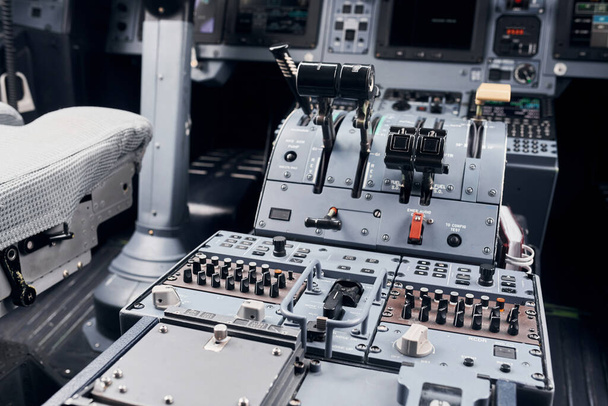 Knobs and buttons. Close up focused view of airplane cockpit. - 写真・画像