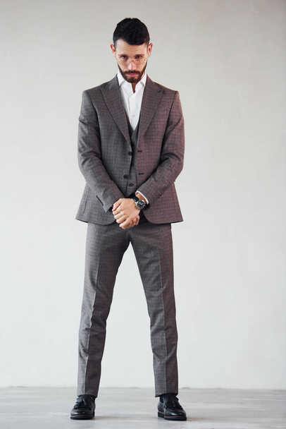Full length photo of young stylish businessman that is in suit indoors. Conception of success. - Fotó, kép