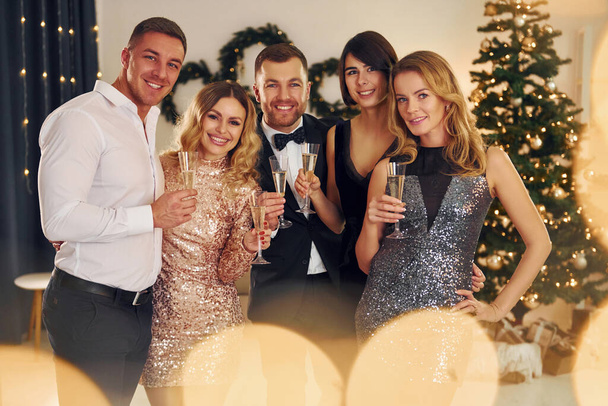X-mas holidays. Group of people have a new year party indoors together. - Φωτογραφία, εικόνα
