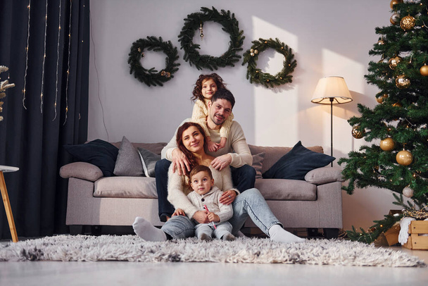 Conception of holidays. Family celebrating new year with their children at home. - Foto, afbeelding