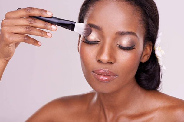 Choose your look. Studio shot of a beautiful young woman with a set of makeup brushes - Fotó, kép