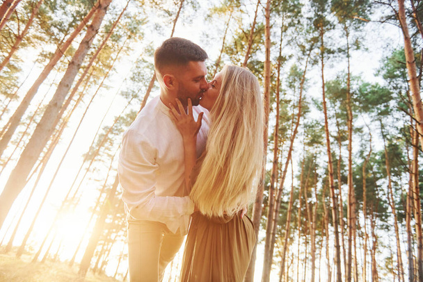Warm weather. Happy couple is outdoors in the forest at daytime. - Foto, immagini