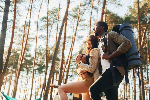 Leisure activities. Young couple is traveling in the forest at daytime together. - Foto, afbeelding