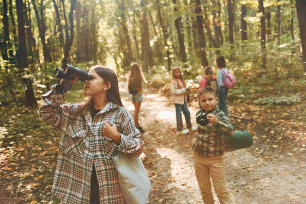 Discovering new places. Kids in green forest at summer daytime together. - Fotografie, Obrázek