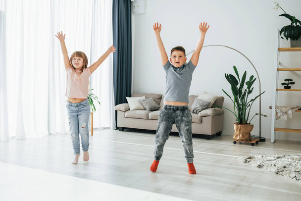 Active weekend time spending. Kids having fun in the domestic room at daytime together. - Fotoğraf, Görsel