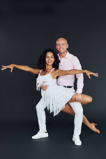 Dancing in the studio. Cheerful couple is together indoors. - Photo, Image