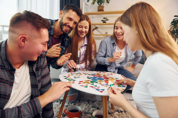 Playing smart game. Group of friends have party indoors together. - Photo, Image
