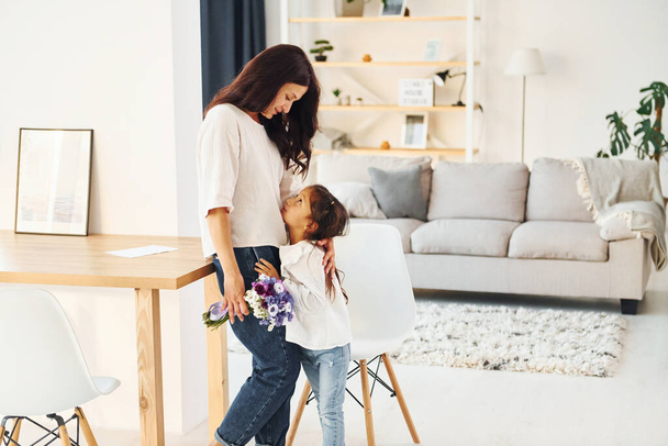 Modern interior. Mother and her daughter spending time together at home. - Foto, Bild