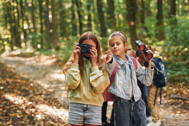 Two friends. Kids in green forest at summer daytime together. - Foto, Imagem