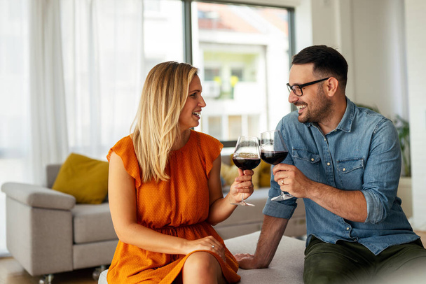 Happy young couple having a romantic date and drinking wine. Couple love romance concept. - Foto, Bild