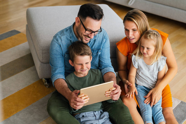 Digital device technology family online education concept. Happy young family with digital devices at home. - Fotoğraf, Görsel